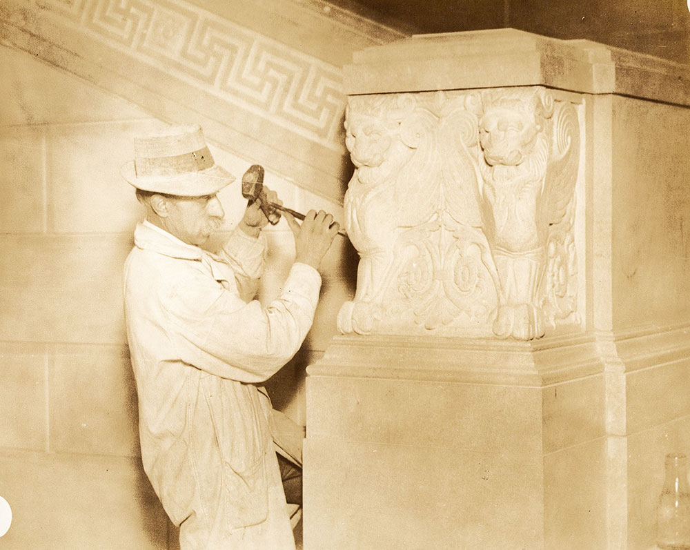 Sculptor from the John Donnelly Company carving one of the pairs of griffins on the main stairway of the Central Library of the Free Library of Philadelphia, 1926