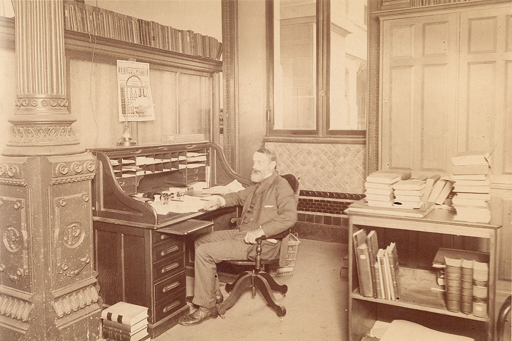 Librarian John Thomson at his desk in Free Library of Philadelphia at City Hall, 1894