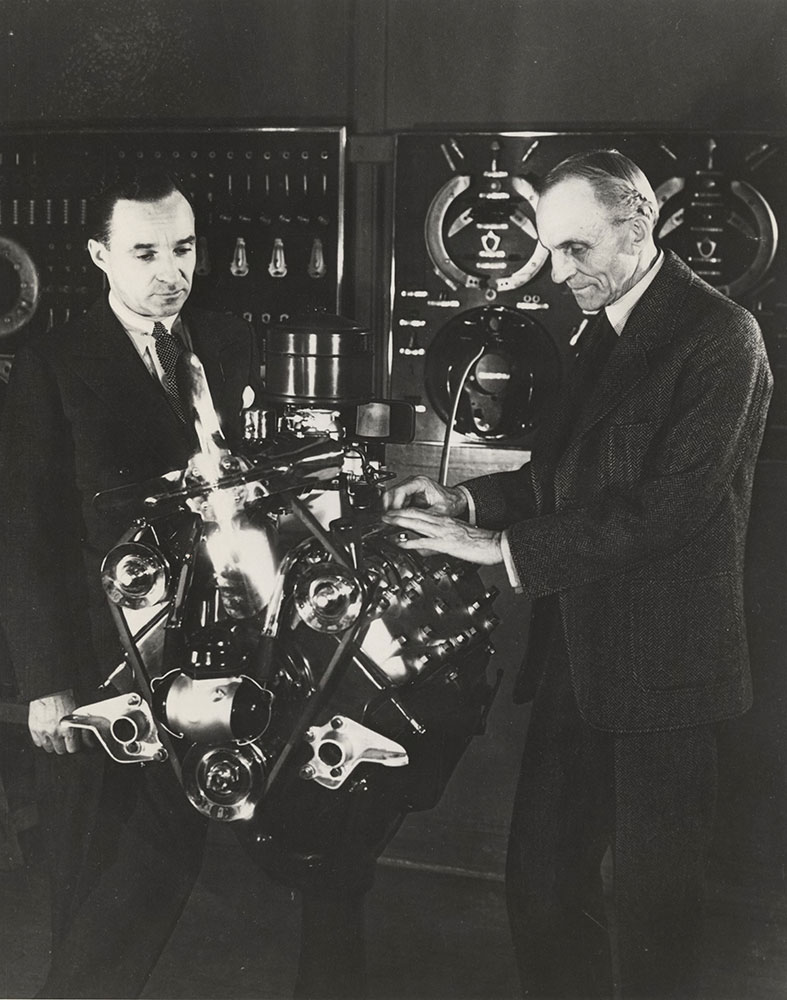 Edsel and Henry Ford and (possibly) their new V-8 engine