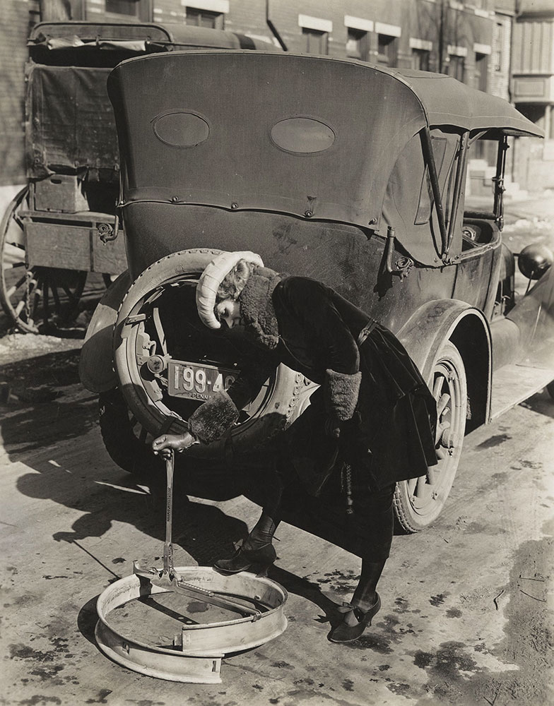 Woman changing a tire