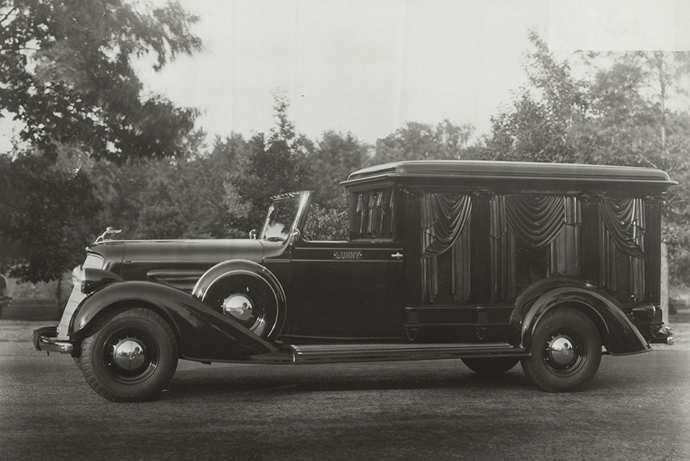 Cunningham hearse built on Oldsmobile chassis. Town car, carved wood and glass, 8 columns
