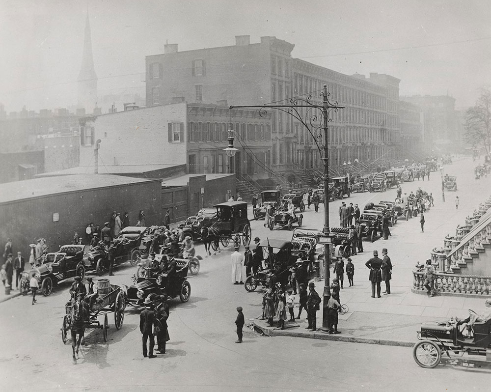 Street scene in New York City  with horses and horseless carriages