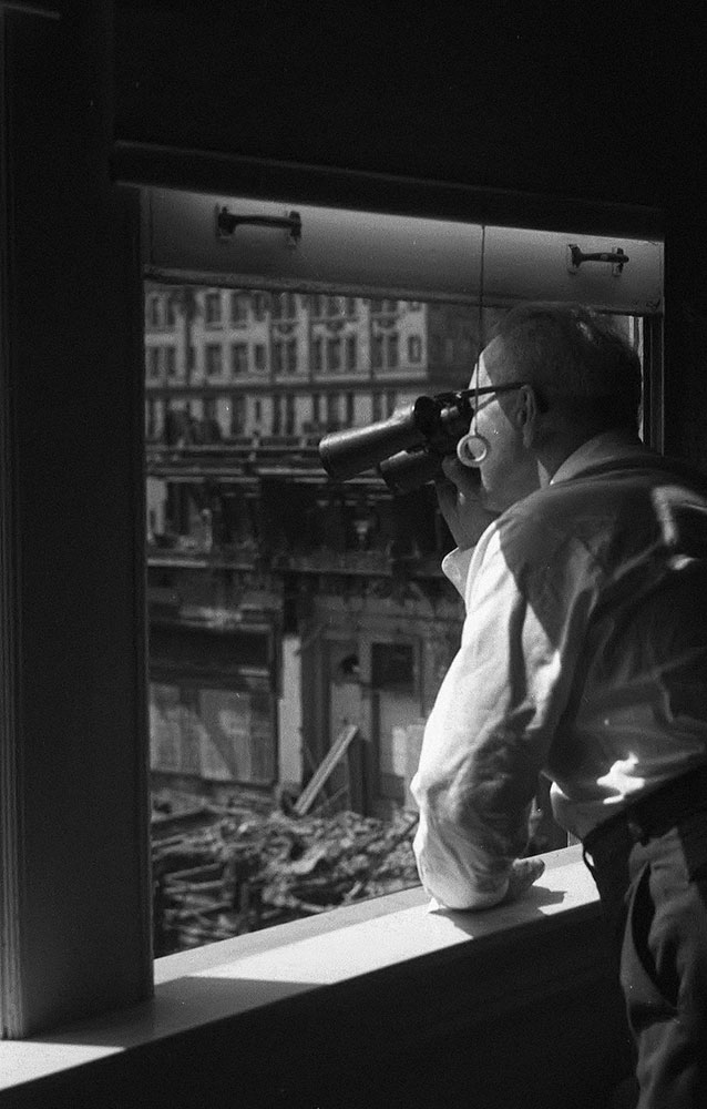 Man Viewing Demolition from Window