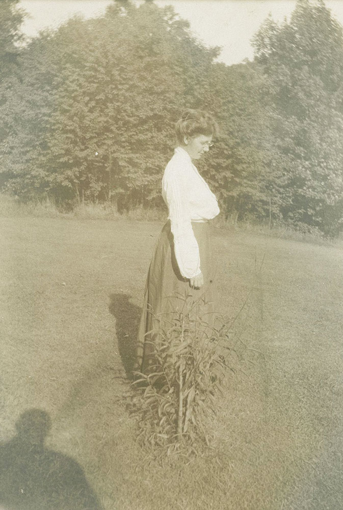Woman Standing near Small Bush