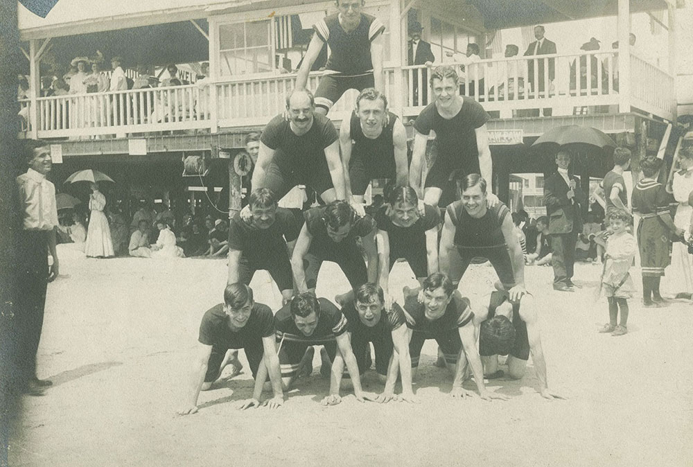 Men in Pyramid Pose on Beach