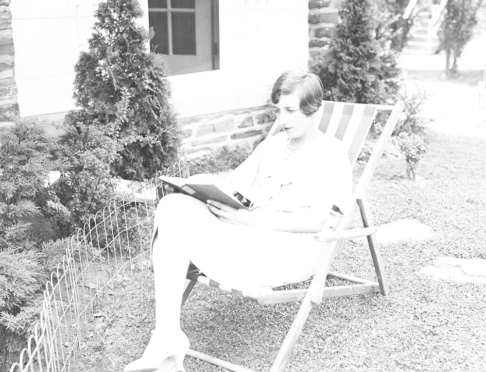Woman sitting and reading outdoors