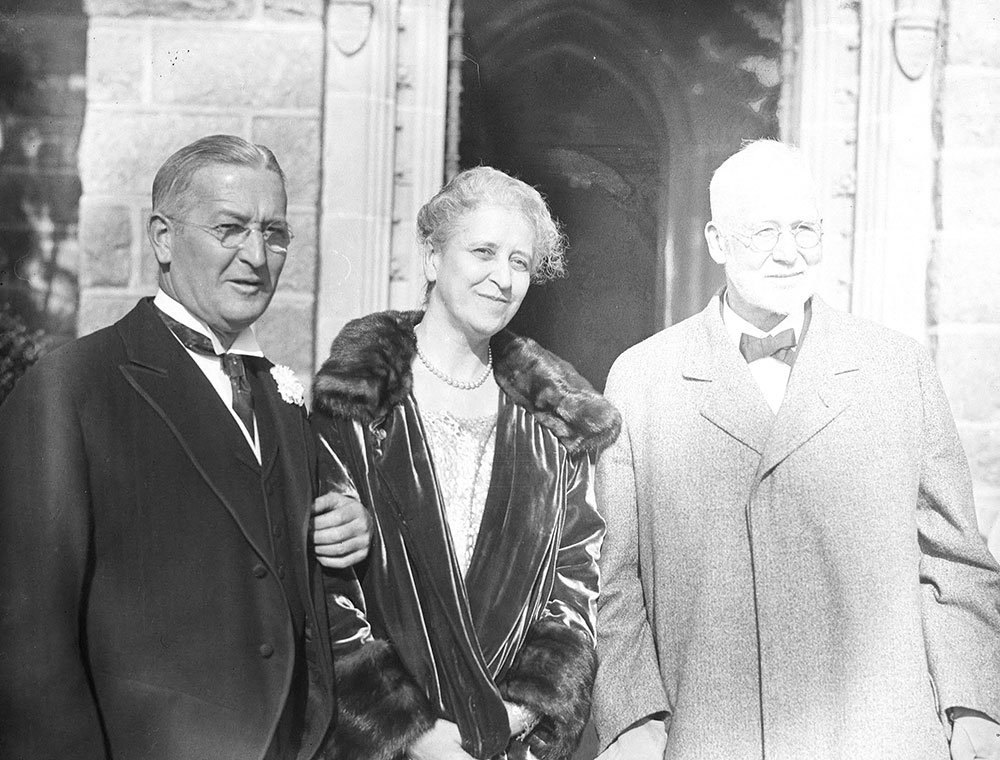 Two men and woman standing outdoors