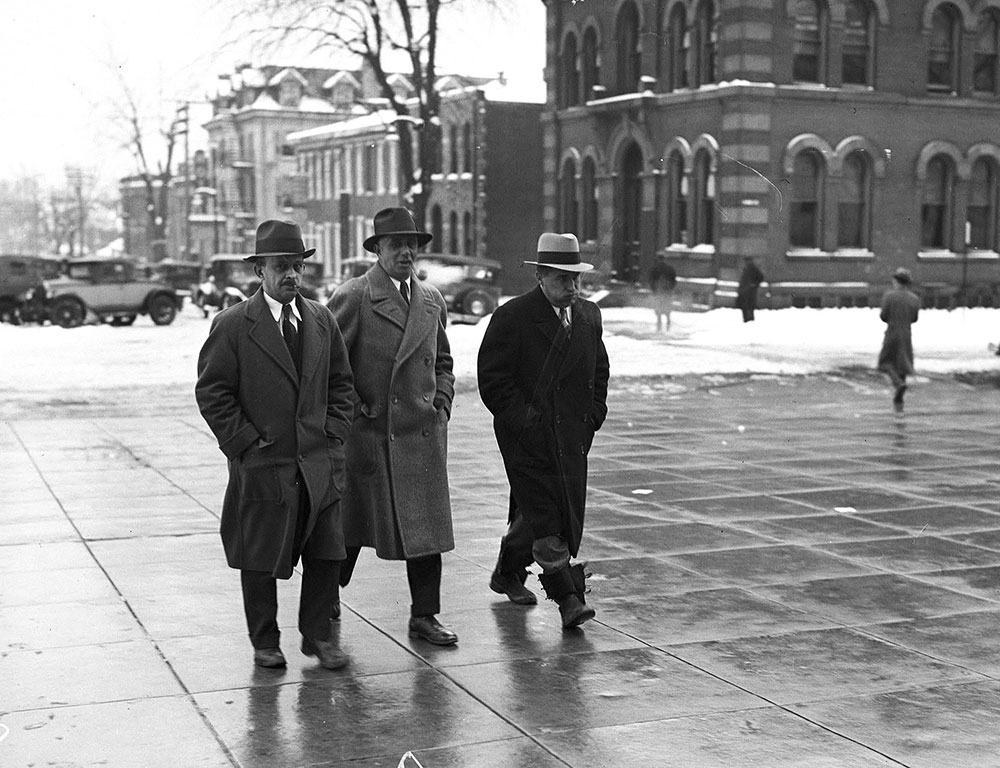 Three men walking outdoors